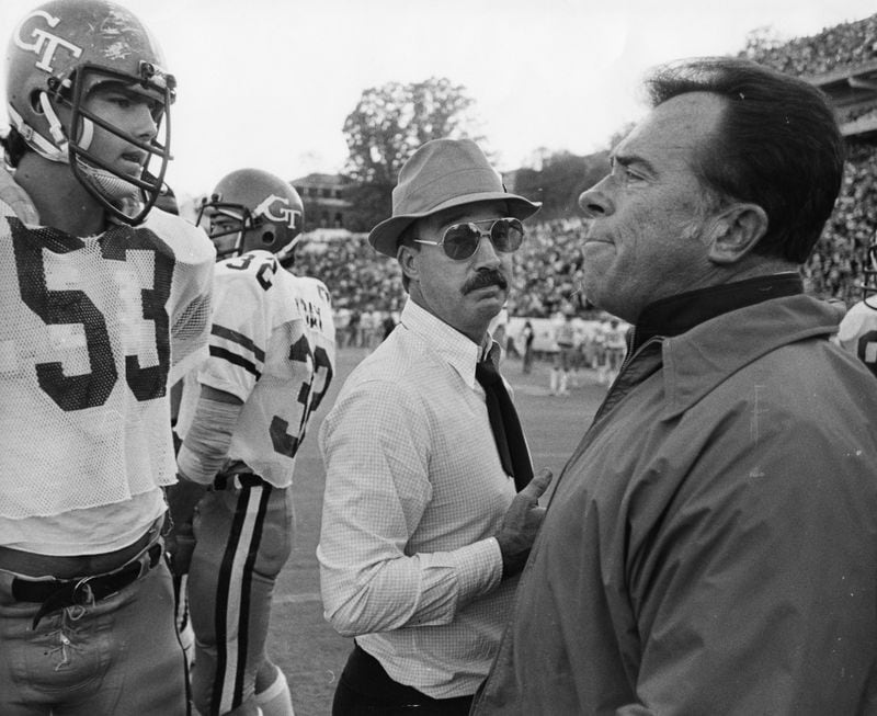 Georgia Tech coach Pepper Rodgers (middle) meets a Notre Dame coach on the field after a heated game in the 1970s. (Joe Benton / AJC)