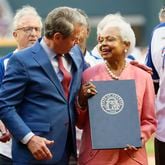 Hank Aaron’s wife, Billye, smiles with Governor Brian Kemp after she was given a proclamation naming April 8th as Hank Aaron Day at Truist Park on Monday, April 8, 2024. Later, the Braves lost the game to the Mets 8-7. 
Miguel Martinez / miguel.martinezjimenez@ajc.com 