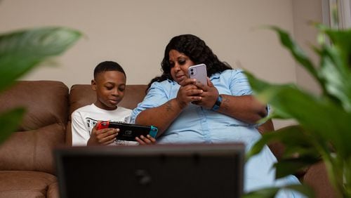 Tiwanda Evans spends the afternoon with her grandson Ralph Jackson at her apartment in Hunter’s Grove Apartments in Austell on Tuesday, February 23, 2021. Because of her asthma and diabetes, health care worker Evans hasn’t been able to work her regular job and has struggled to pay her rent. (Rebecca Wright for The Atlanta Journal-Constitution)
