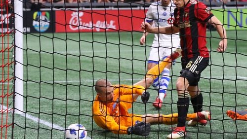 Atlanta United midfielder Jeff Larentowicz scores an apparent goal past Montreal Impact goalkeeper Evan Bush but the United were ruled offsides on the play during the first half in a MLS soccer game on Saturday, April 28, 2018, in Atlanta.  Curtis Compton/ccompton@ajc.com