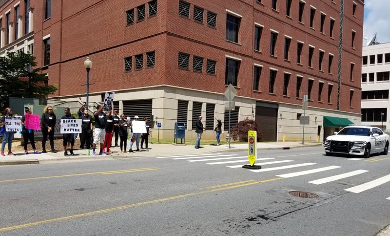 Activists protest the treatment of Renardo Lewis by Marietta police Friday outside the Cobb County courthouse.