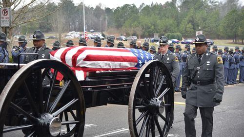 The funeral for Georgia Trooper Chase Redner was held Tuesday in Canton. Redner, 31, was killed while investigating a crash on Feb. 20 in Clayton County. Leah Owens, Redner's fiancé, and Linda Stancil-Redner, his mother, received flags during the burial ceremony.