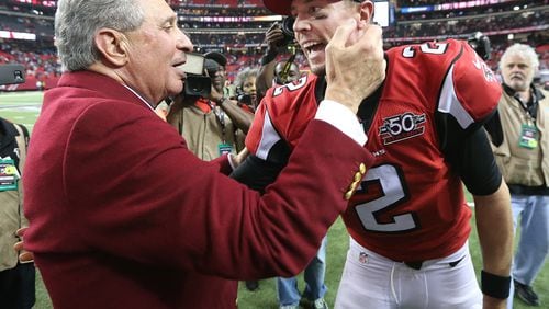 Falcons owner Arthur Blank and quarterback Matt Ryan celebrate ending Carolina's perfect season with a 20-13 victory at the Georgia Dome. (Curtis Compton/ccompton@ajc.com)