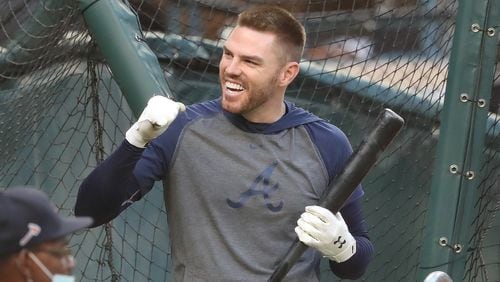 Braves first baseman Freddie Freeman smiles and pumps his fist for some cheering fans at the end of batting practice Friday, Oct. 16, 2020, before Game 5 of the National League Championship Series against the Lost Angeles Dodgers at Globe Life Field in Arlington, Texas. (Curtis Compton / Curtis.Compton@ajc.com)