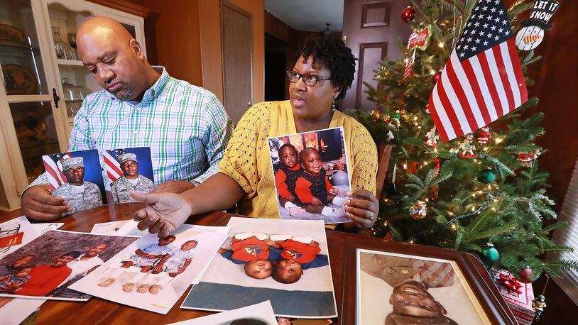 Chris and Sandra McBride look through childhood photos of their twin sons, Matthew and Ryan, at their home in Statesboro. The parents said their Christian faith helps them cope with their sons’ upcoming deployment. “We are praying about it and honestly trusting in God and believing that he is going to take care of them,” Sandra said. Curtis Compton/ccompton@ajc.com