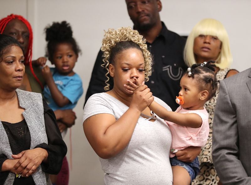 061520 Atlanta: Tomika Miller, the wife of Rayshard Brooks, holds their daughter Memory, 2, gently kissing her hand during the family press conference on Monday, June 15, 2020, in Atlanta. Brooks was killed by an APD officer Friday.  Curtis Compton ccompton@ajc.com