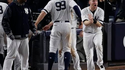 New York Yankees' Todd Frazier celebrates after Aaron Judge scored during the eighth inning of Game 4 of baseball's American League Championship Series against the Houston Astros Tuesday, Oct. 17, 2017, in New York. (AP Photo/Frank Franklin II)