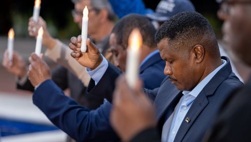 220420-Atlanta-Sherman Hampton and others hold candles during a vigil for the victims of gun violence held by members of 100 Black Men of Atlanta on Wednesday evening, Apr. 20, 2022 at the King Center.  Ben Gray for the Atlanta Journal-Constitution