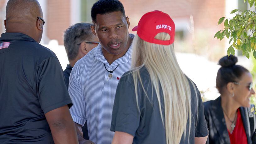 Republican Senate candidate Herschel Walker, facing, talks with former University of Kentucky swimmer Riley Gaines during the 'Unite Georgia Bus Tour,’ at the The Mill on Etowah, Tuesday, September 27, 2022, in Canton, Ga. (Jason Getz / Jason.Getz@ajc.com)