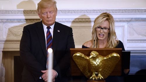 President Donald Trump listens to evangelist and pastor Paula White as she leads the prayer during a dinner for evangelical leadership in the State Dining Room of the White House in Washington, D.C., on August 27, 2018.(Olivier Douliery/Sipa USA/TNS)