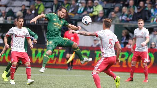 Portland’s Sebastian Blanco, center, tries to corral the ball as Atlanata’s Leandro Gonz’lez Pirez (5) defends as the Portland Timbers hosted Atlanta United FC in a MLS match at in Portland, Ore., Sunday, May 14, 2017. (Sean Meagher/The Oregonian via AP)