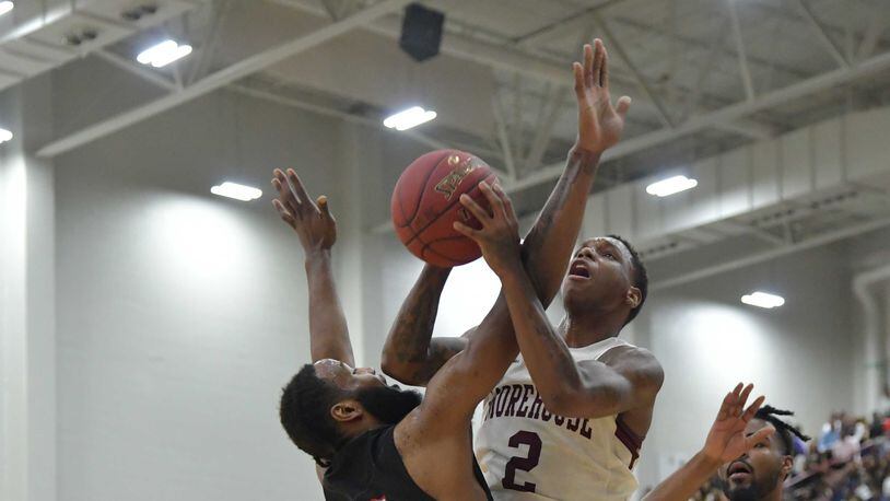 Morehouse Tyrius Walker (2) grabs a rebound over Clark Atlanta Michael Vigilance (15) during the Morehouse vs Clark Atlanta college basketball game at Morehouse's Forbes Arena on Friday, February 22, 2018.