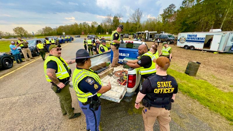 Law enforcement officers search a truck last weekend at an annual license and sobriety checkpoint along I-16 in Twiggs County. (Joe Kovac Jr. / joe.kovac@ajc.com)