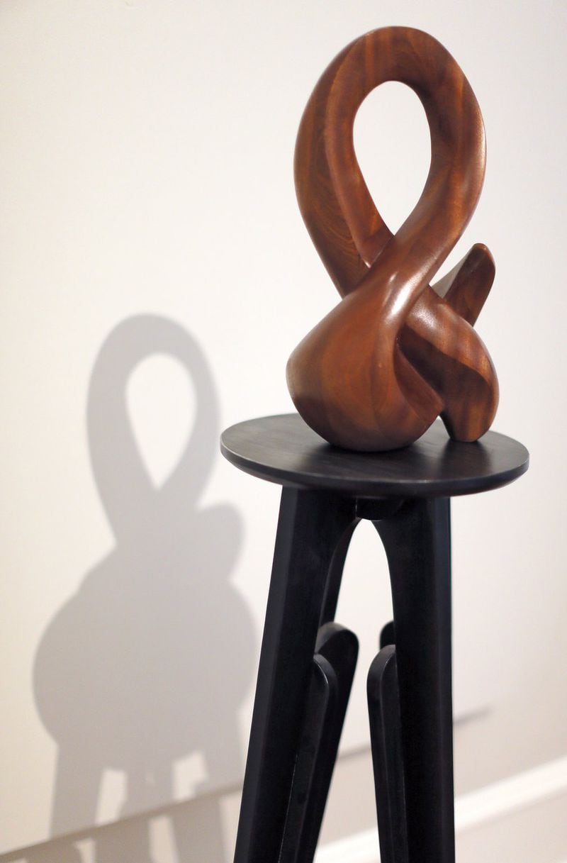 “Ampersand,” in mahogany, is by Atlanta sculptor Tom Williams. While wood remains his most popular form, bronze and marble have also entered the mix in recent years. BOB ANDRES /BANDRES@AJC.COM
