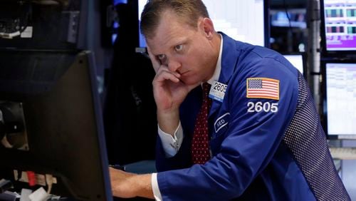 Specialist Edward Zelles works on the floor of the New York Stock Exchange, Thursday, Aug. 20, 2015. The Dow Jones industrial average slid 358 points, also 2.1 percent, to 16,990. (AP Photo/Richard Drew)