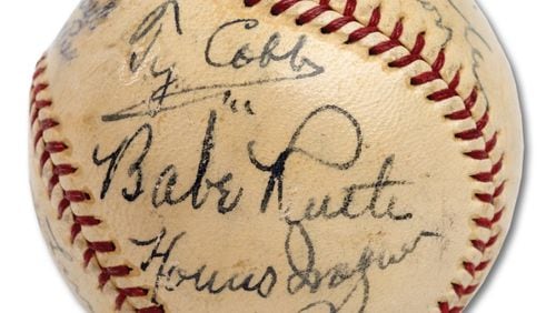 A baseball containing signatures of 11 Hall of Famers -- including Ty Cobb, Babe Ruth and Honus Wagner -- sold for more than $623,000 Sunday.