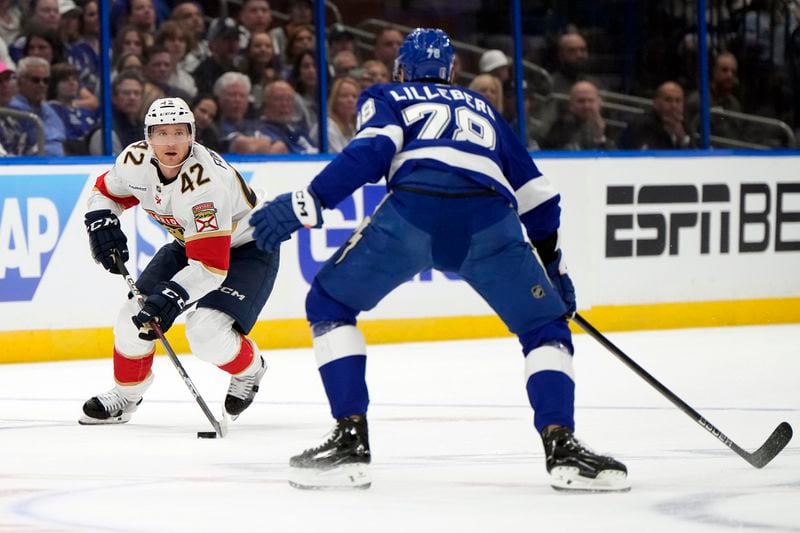 Florida Panthers defenseman Gustav Forsling (42) tries to work around Tampa Bay Lightning defenseman Emil Lilleberg (78) during the first period in Game 3 of an NHL hockey Stanley Cup first-round playoff series, Thursday, April 25, 2024, in Tampa, Fla. (AP Photo/Chris O'Meara)
