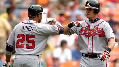Andruw Jones (left) began a guest-instructor stint at Braves spring training Sunday, and Chipper Jones (right) is to be in camp Monday. (Getty Images)