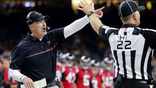 Atlanta Falcons head coach Dan Quinn challenges an official in the first half of an NFL football game against the New Orleans Saints in New Orleans, Monday, Sept. 26, 2016. (AP Photo/Butch Dill)