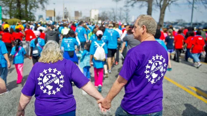 June Woodside (left) holds hands with Donald Palguta as they walk in the Hunger Walk/Run 2013.