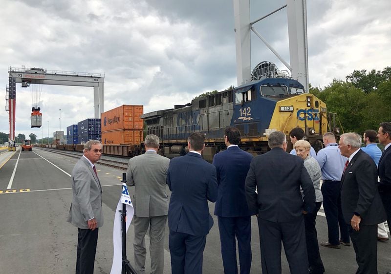 Dignitaries, including Gov. Nathan Deal, right, watch the hoisting of the ceremonial first container from a train onto a truck at the Appalachian Regional Port in Crandall, Ga., on Wednesday August 22, 2018. The Georgia Ports Authority’s new inland port is expected to handle 50,000 containers a year and potentially double that capacity in the next 10 years. J. SCOTT TRUBEY/STRUBEY@AJC.COM