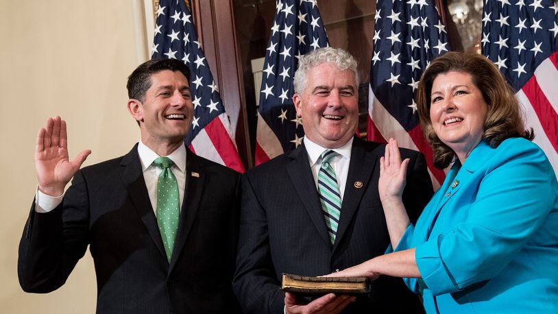 U.S. House Speaker Paul Ryan, from left, Steve Handel and U.S. Rep. Karen Handel, R-Ga., participate in a ceremonial swearing-in Monday on Capitol Hill. (Photo by Drew Angerer/Getty Images)