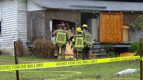Gwinnett County firefighters examine a house in unincorporated Loganville that burned Saturday morning. A 76-year-old man died in the fire. (Credit: Gwinnett Fire and Emergency Services)