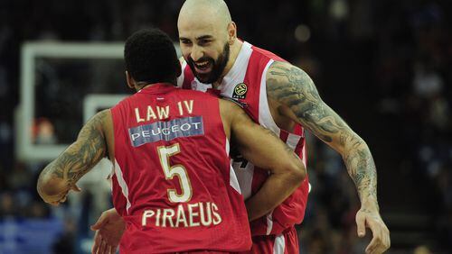 LONDON, ENGLAND - MAY 12: Acie Law and Pero Antic of Olympiacos Piraeus celebrate victory during the Turkish Airlines EuroLeague Final Four final between Olympiacos Piraeus and Real Madrid at the O2 Arena on May 12, 2013 in London, England. (Photo by Jamie McDonald/Getty Images)