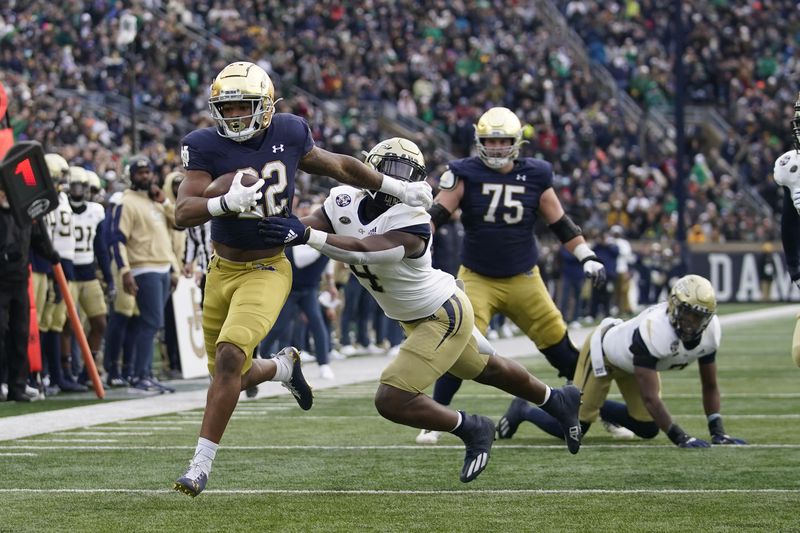 Notre Dame's Logan Diggs (22) runs past Georgia Tech's Quez Jackson (4) for a touchdown during the first half of an NCAA college football game Saturday, Nov. 20, 2021, in South Bend, Ind. (AP Photo/Darron Cummings)