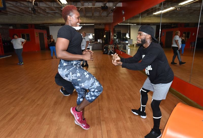 Dwight Holt, celebrity dance fitness instructor, encourages his student Diana Marcelin at Rhythma Studios at a session in May. Holt’s work with Oscar-winning actress Mo’Nique garnered national attention. HYOSUB SHIN / HSHIN@AJC.COM