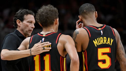 Hawks coach Quin Snyder confers with guards Trae Young (11) and Dejounte Murray (5) during the second half in Game 3 of the first round of the Eastern Conference playoffs at State Farm Arena, Friday, April 21, 2023, in Atlanta. (Hyosub Shin / Hyosub.Shin@ajc.com)