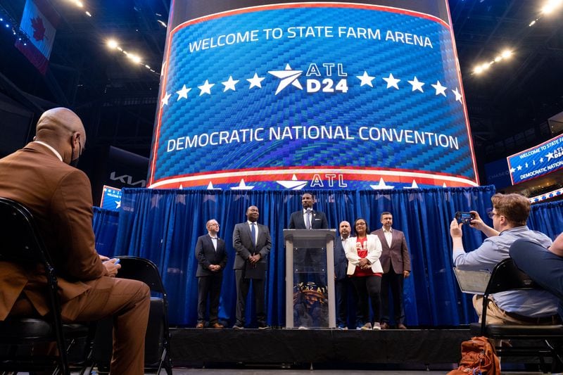 Atlanta Mayor Andre Dickens, Democratic National Committee Chair Jaime Harrison and U.S. Rep. Nikema Williams speak to journalists after touring State Farm Arena in July. The arena would be the host site for the 2024 Democratic National Convention if Atlanta wins its bid.  Ben Gray for The Atlanta Journal-Constitution