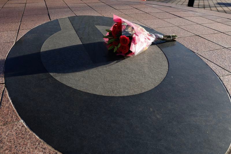A lone bouquet of flowers rests outside the Butts-Mehre Football complex in memory of University of Georgia  football player Devin Willock and football staff member Chandler LeCroy who died in a car accident on Sunday, January 15, 2023.  (Natrice Miller/natrice.miller@ajc.com) 