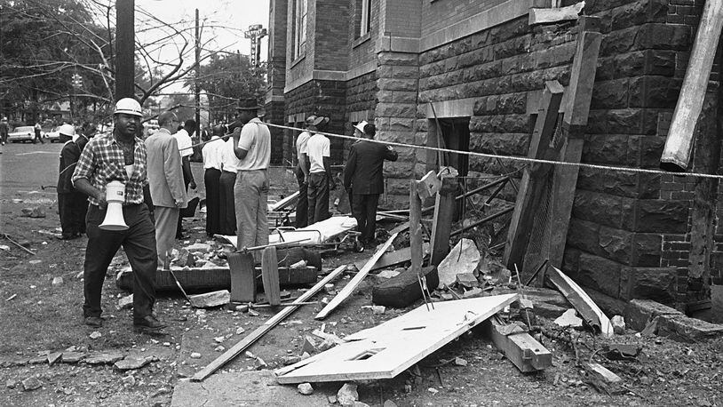 In a Sept. 15, 1963 file photo, investigators work outside the 16th Street Baptist Church in Birmingham, Ala., following an explosion that killed four young girls. AP Photo/File