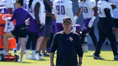 Minnesota Vikings head coach Mike Zimmer watches his players during the first day of mandatory minicamp in June in Eagan, Minnesota. Vikings assistant coach Rick Dennison was fired Friday for refusing to get the COVID-19 vaccine, which the NFL has made a requirement for all its top-level employees, according to a report by ESPN.