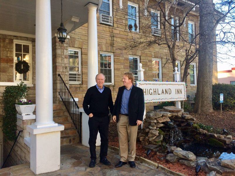 Tom Carmichael, owner of the Highland Inn and many other Poncey-Highland properties, says the effort to create a historic district will hurt him financially and make it harder to keep affordable housing. He’s shown here with his son, Thomas. (Photo by Bill Torpy)