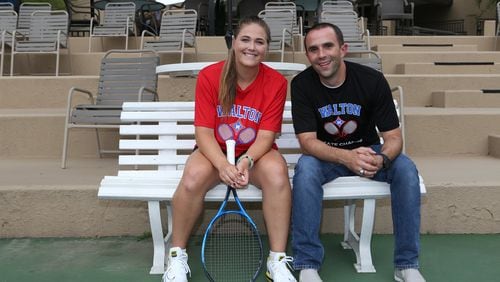 Liz Norman (left) and her coach Anthony Foti (right) pose for a portrait at the Olde Towne Athletic Club tennis courts in Marietta, Georgia, on May 12, 2017. After being shifted up to Class AAAAAAA, the Walton High School girl’s tennis team stepped up and won the state championship, while Norman herself went undefeated in a 17-0 season. She was recently ranked as the 53rd tennis player in the United States for her class, and as a five star recruit will attend James Madison University in the fall. (HENRY TAYLOR / HENRY.TAYLOR@AJC.COM)
