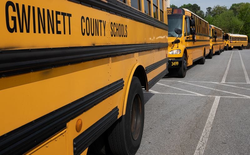Gwinnett County buses line up in front of Berkmar High School in Lilburn on Tuesday morning April 7, while waiting to deliver lunches to students in the district. Ben@BenGray.com for the Atlanta Journal-Constitution