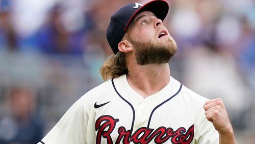 Braves relief pitcher A.J. Minter (33) reacts after getting Los Angeles Dodgers pinch hitter Max Muncy to pop out for the final out in the seventh inning Sunday, June 6, 2021, in Atlanta. (Brynn Anderson/AP)
