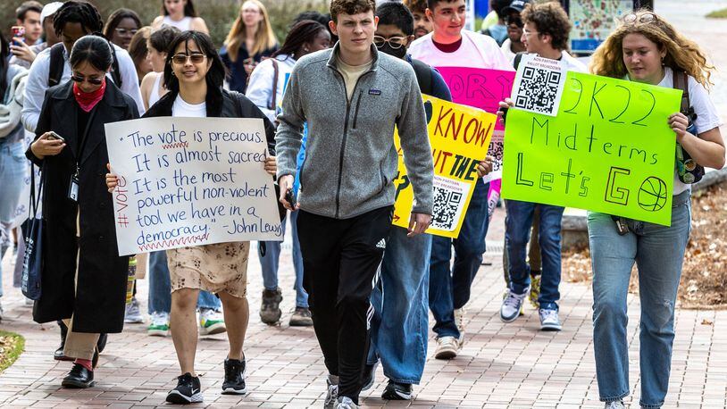 Students march to the polling site on Emory University’s campus during a Vote Early Day party on Oct. 28, 2022. (Steve Schaefer/The Atlanta Journal-Constitution/TNS)
