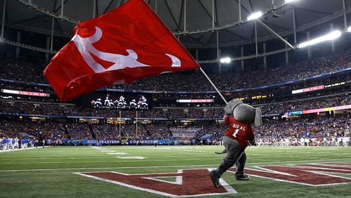 Mascot Big Al of the Alabama Crimson Tide carries a flag across the field during the 2015 SEC Championship game against the Florida Gators at the Georgia Dome in Atlanta.