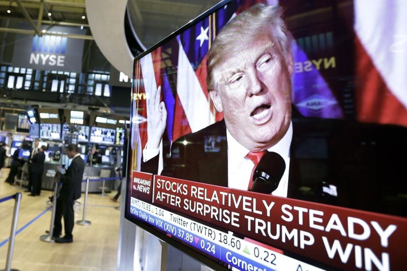 An image of President-elect Donald Trump appears on a television screen on the floor of the New York Stock Exchange, Wednesday, Nov. 9, 2016. Stock futures nosedived as a Trump victory became likely overnight, but after the president-elect’s first remarks the Dow gained nearly 257 points on the day. (AP Photo/Richard Drew)