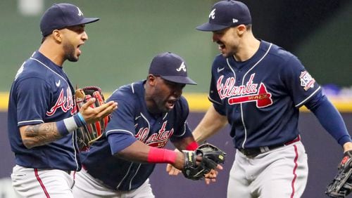 Braves outfielders Eddie Rosario (8), Jorge Soler (12) and Adam Duvall (14) celebrate the 3-0 victory in Game 2 of the NLDS series against he Milwaukee Brewers Saturday, Oct. 9, 2021, in Milwaukee. (Curtis Compton / Curtis.Compton@ajc.com)