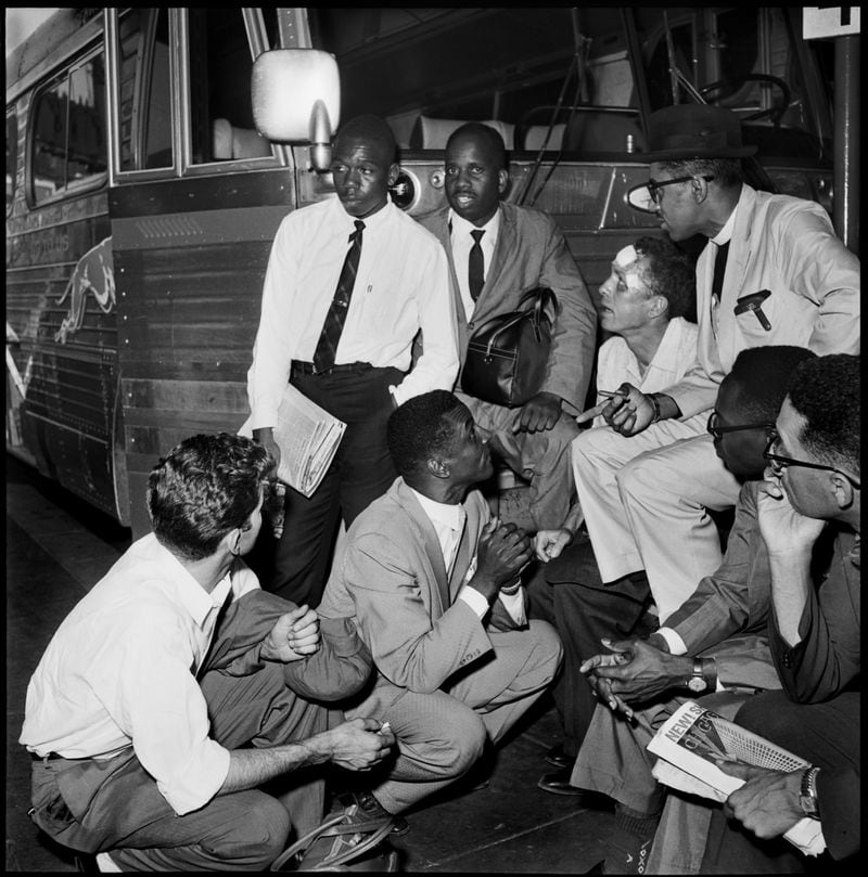 Freedom Riders, including Charles Person, standing at left, crowd around the Rev. Fred Shuttlesworth and discuss plans at the Birmingham Greyhound terminal on May 15, 1961, after drivers refused to carry them any farther. Later, the riders caught a plane out of Birmingham to New Orleans. Surrounding Shuttlesworth, clockwise from left: Ed Blankenheim, kneeling, Person, Ike Reynolds, James Peck, Rev. Benjamin Cox, and two unidentified Freedom Riders. (AP Photo/The Birmingham News)