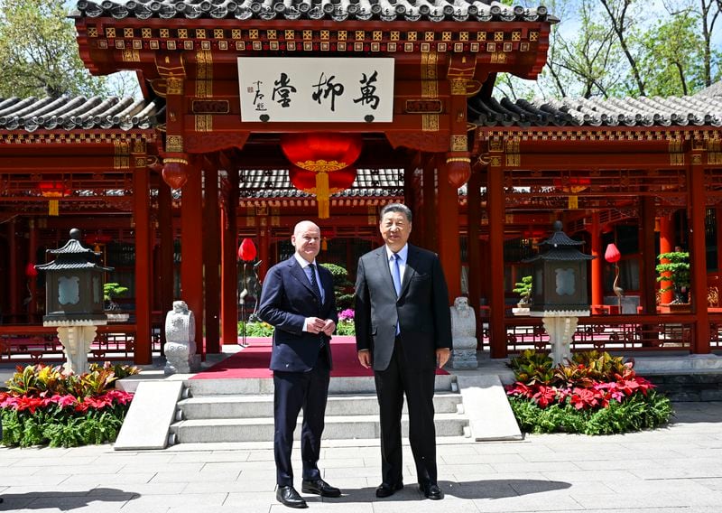 In this photo released by Xinhua News Agency, Chinese President Xi Jinping, right and German Chancellor Olaf Scholz pose for a photo in Beijing, China, on Tuesday, April 16, 2024. (Xie Huanchi/Xinhua via AP)
