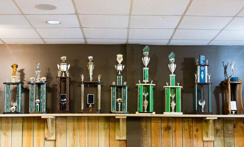 A shelf of trophies overlooks the ordering line at Dave Poe’s BBQ — a reminder that it is part of one of Atlanta’s lasting barbecue legacies. CONTRIBUTED BY HENRI HOLLIS