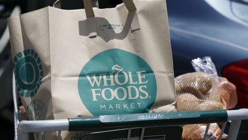 Groceries sit in a cart outside a Whole Foods store in an AP file photo.