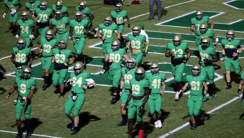 Buford players warm up before Friday's home game against Dacula.