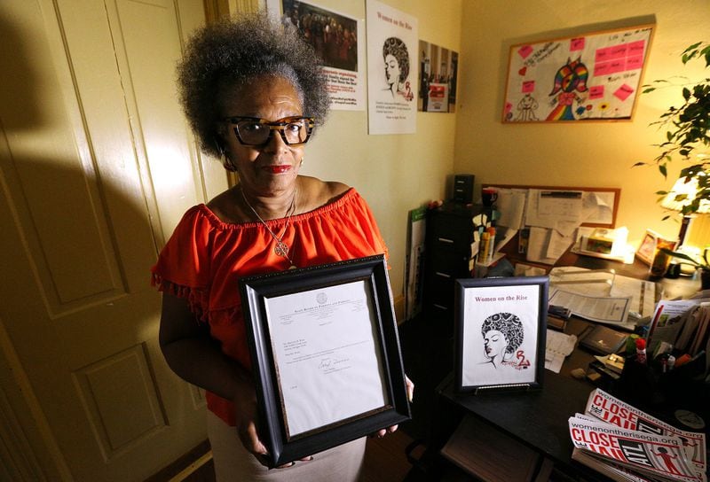 Marilynn B. Winn, director of two non-profits that advocate for formerly incarcerated people, holds the pardon she was granted by the state of Georgia in her office at Women on the Rise on Wednesday, August 23, 2018, in East Point. Curtis Compton/ccompton@ajc.com