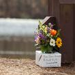 Mourners laid flowers at Lake Herrick in Athens at the University of Georgia on Friday, Feb. 23, 2024. Laken Riley, a 22-year-old, nursing student was found dead nearby on Thursday. (Jason Getz/The Atlanta Journal-Constitution)